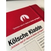 Notizbuch in rotem Hardcover mit Prägung und punktkariertem Innenteil.