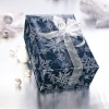 Geschenk verpackt in blauem Papier mit Schneeflockenmotiven und transparentem Band.