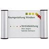 Türschild mit Cliprahmen, beschriftet mit "Raumgestaltung Windken" und "Vertriebsleitung".
