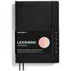 Schwarzes Notizbuch mit Aufschrift "Learning Journal" und farbigem Logo auf der Vorderseite.