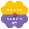 Blumenförmige Schachtel mit der Aufschrift "DANKE SCHÖN" und einer Milka Praline in der Mitte.