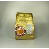 Goldene Kaffeeverpackung mit buntem Teller und Tasse auf der Vorderseite.