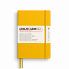 Gelbes, liniert Notizbuch im A5-Format mit Softcover und Gummibandverschluss.