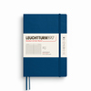 Blaues Softcover-Notizbuch im A5-Format mit linierter Seiten.