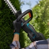 GARDENA Heckenschere EasyCut 55/18V in Aktion beim Schneiden einer Hecke.