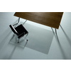 Transparente Bodenschutzmatte unter einem Tisch mit schwarzem Bürostuhl auf weichem Boden.