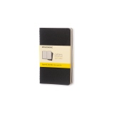 Schwarzes Notizheft im Pocket-Format mit karierten Seiten und gelbem Etikett.