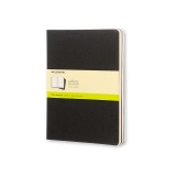Schwarzes Moleskine Cahier XL Notizheft mit leichtem Pappeinband und gelber Umverpackung.