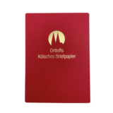 Rote Briefpapiermappe mit goldener Aufschrift „Ortloffs Kölsches Briefpapier“.