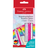 Zwei Tuben Regenbogenglitzer in Verpackung mit Farbmustern und Pinsel im Hintergrund.