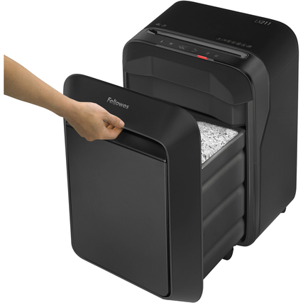Aktenvernichter mit geöffnetem Auffangbehälter und Hand, die Papierpartikel zeigen.