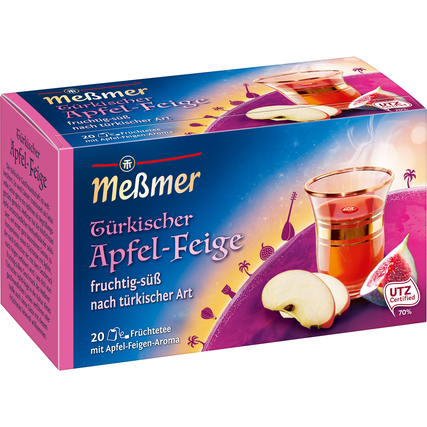 Paket der Meßmer Tee-Sorte Türkischer Apfel-Feige mit einer Tasse Tee und Obst.