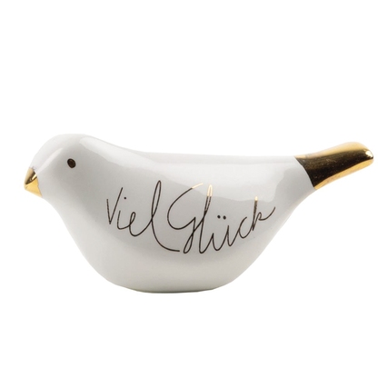 Dekorationsfigur in Form eines Vogels mit Aufschrift "Viel Glück" und goldfarbenem Schnabel.