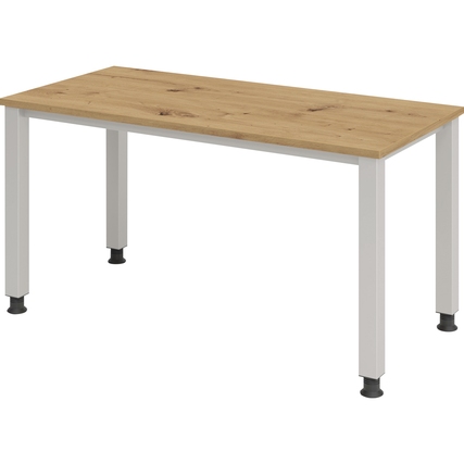 Schreibtisch mit eichefarbenem Tischplatte und weißen Metallbeinen, Seitenansicht.