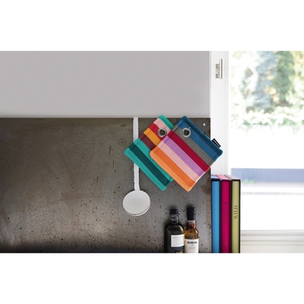 Zwei dekorative Topflappen hängen in einer modernen Küche an der Wand.