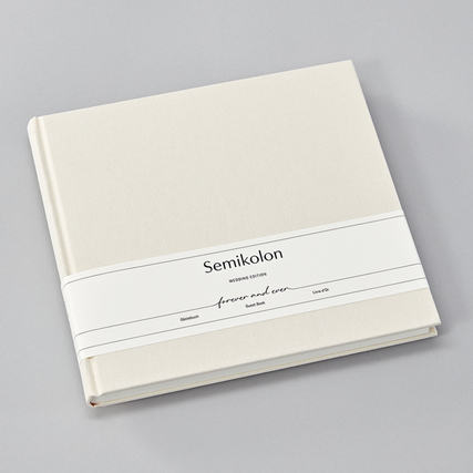 Weißes Gästebuch mit Buchleinenbezug und einem Band, passend für Hochzeiten und Jubiläen.