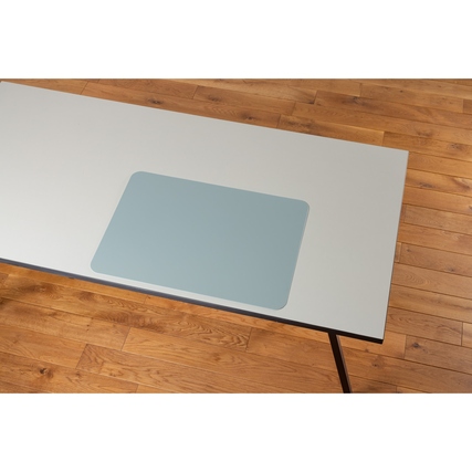 Schreibunterlage in soft aqua auf einem Tisch aus Holz, mit neutralem Hintergrund.