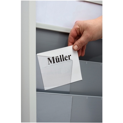 Hand hält ein beschriftetes Blatt Papier, das in eine Kartentafel eingelegt wird.