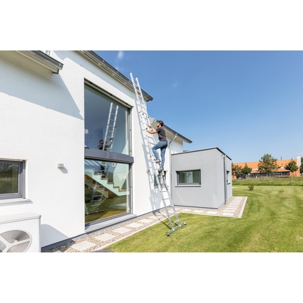 Multifunktionsleiter, die als Steh-, Anlege- und Schiebeleiter verwendet wird, an einem Haus.