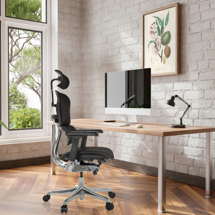 Ergonomischer Bürodrehstuhl mit 2D-Kopfstütze vor einem Schreibtisch mit Monitor und Lampe.
