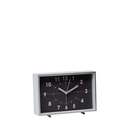 Tischuhr im Vintage-Design mit schwarzem Zifferblatt und weißen Zahlen auf einem grauen Gehäuse.