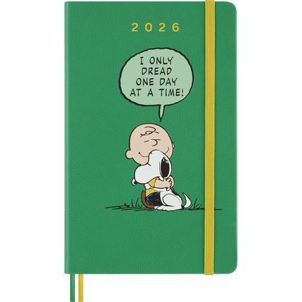 Grüner Buchkalender 2026 mit Charlie Brown und Snoopy auf dem Cover und gelbem Gummiband.