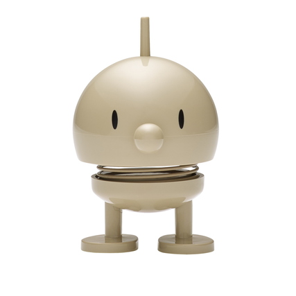 Helles, runde Dekorationsfigur mit einem fröhlichen Ausdruck und flexiblen Federbeinen.