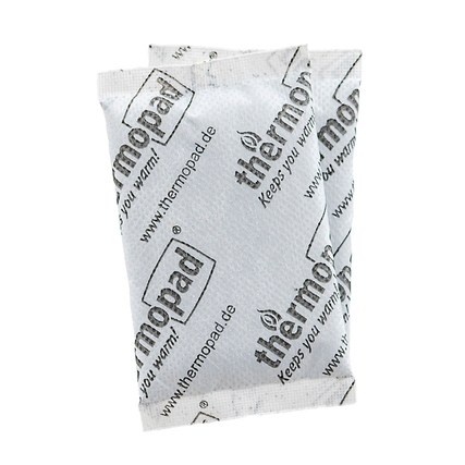 Zwei Handwärmer in einer neutralen Verpackung mit dem Markennamen und Nutzungshinweisen.