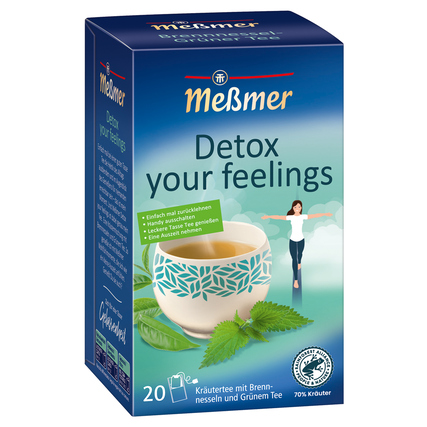 Packung von Meßmer Tee "Detox your feelings" mit einer Tasse Tee und Kräutern auf dem Bild.