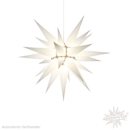 Weißer Papierstern mit spitzen Zacken, hängend und beleuchtet, Durchmesser 60 cm.