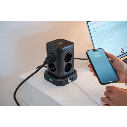 Tischsteckdosenleiste im Turmdesign mit drei Steckdosen und USB-Anschluss, genutzt am Schreibtisch.