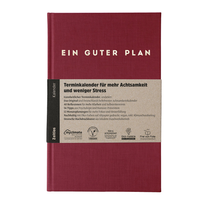 Roter Buchkalender mit Aufschrift und Beschreibung für mehr Achtsamkeit und Selbstliebe.