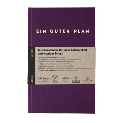 Violetter Buchkalender mit der Aufschrift „EIN GUTER PLAN“ für Achtsamkeit und Stressbewältigung.