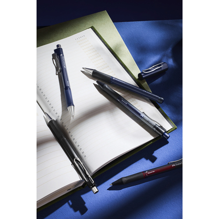 Faber-Castell Gelschreiber in verschiedenen Farben auf einem Notizbuch.