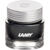 Glastiegel mit grauer Tinte und silbernem Deckel, beschriftet mit 'LAMY'.