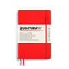 Rotes Notizbuch im DIN A5 Format mit Softcover und Gummiband, linierte Seiten sichtbar.